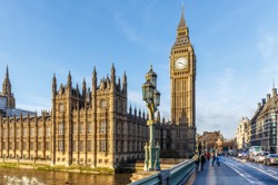 Photo of the Houses of Parliament and Big Ben, taken from Westminster bridge, with a bright blue sky.