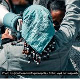 Image of back of woman holding megaphone