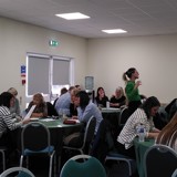 Photo of participants sitting at round tables engaged in activity